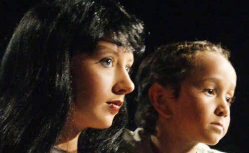 Grace Cockburn onstage in her award-winning performance as the tragic bar girl, Kim, in Miss Saigon. Grace Cockburn onstage in her award-winning performance as the tragic bar girl, Kim, in Miss Saigon.
